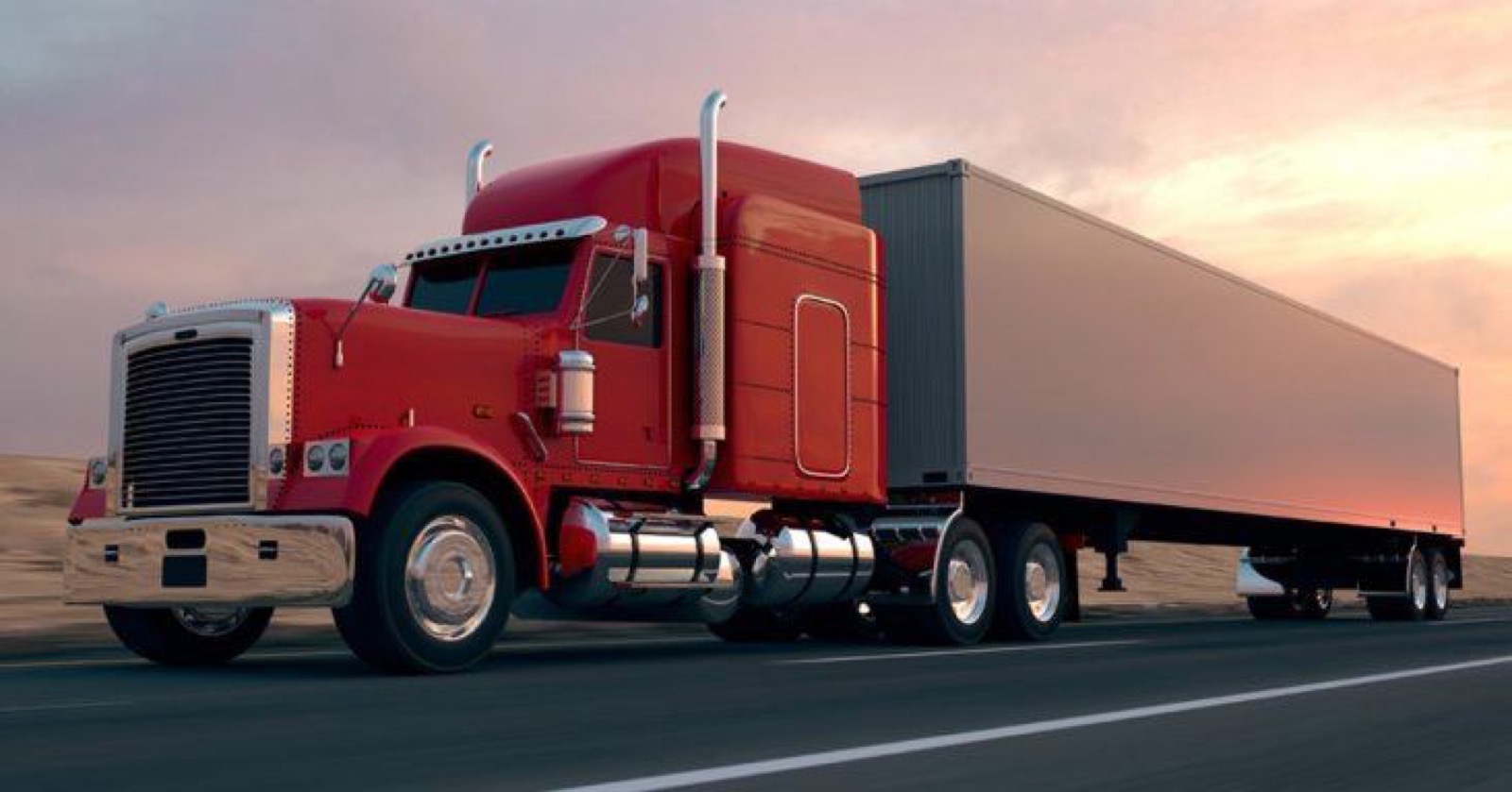 Semi truck hauling a dry van trailer at sunset